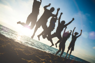 stock-photo-60766134-group-of-friends-jumping-on-the-beach-at-dusk